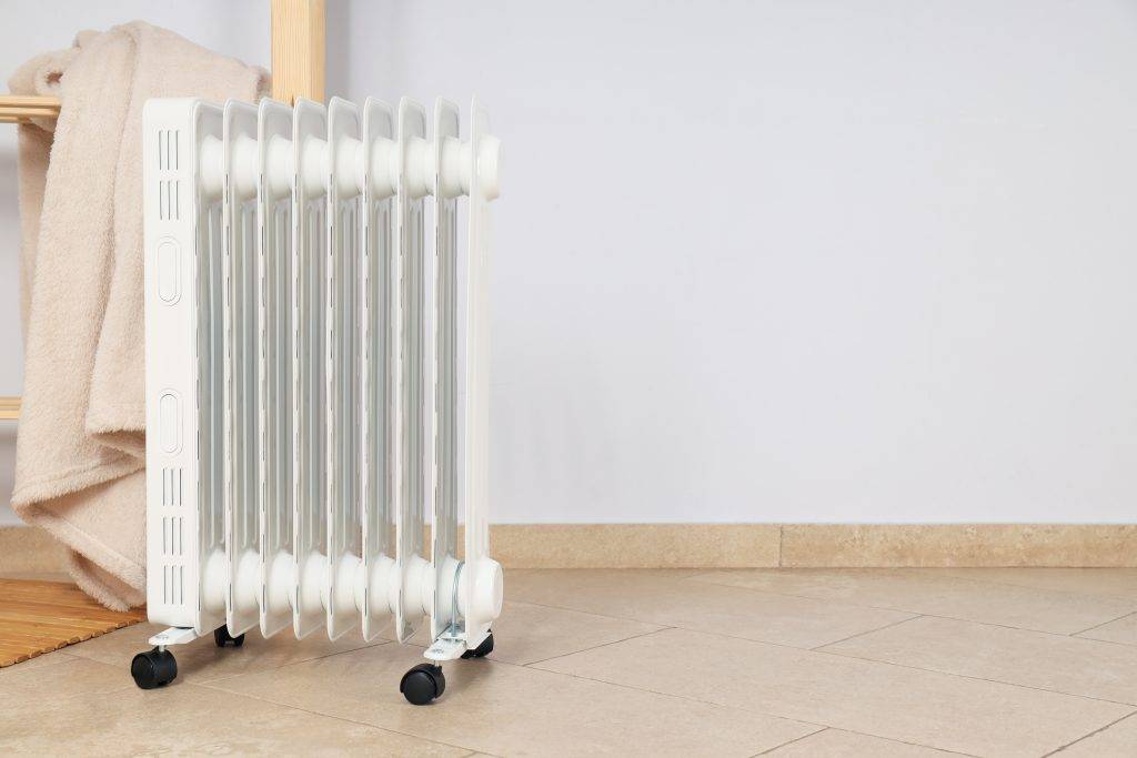 Concept of heating season, modern electric heater in room