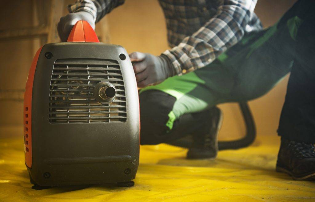 Construction Worker Preparing Gasoline Electricity Generator To Work