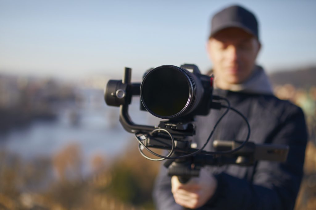 Content creator during filming with camera and gimbal