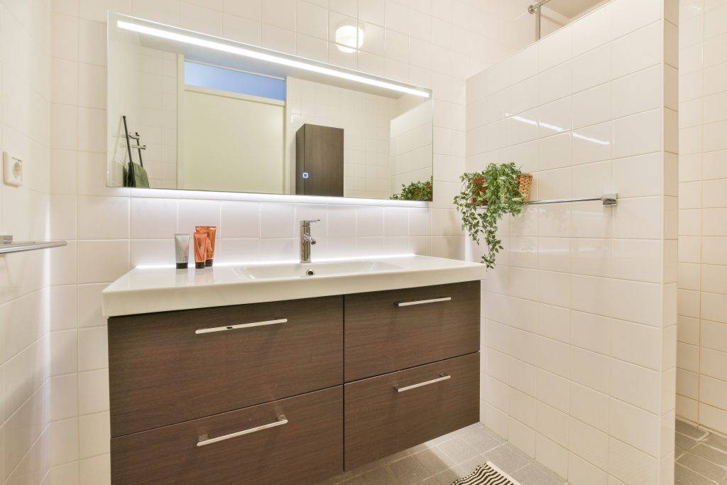 Interior of modern bathroom with bathtub and mirror