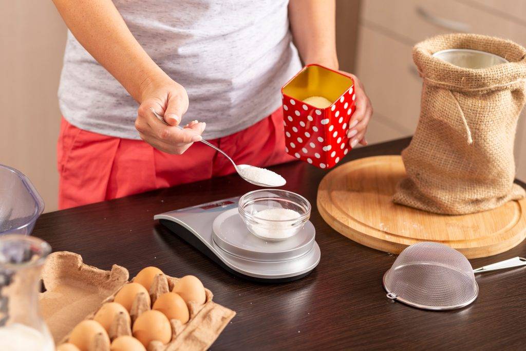 Woman using kitchen scale