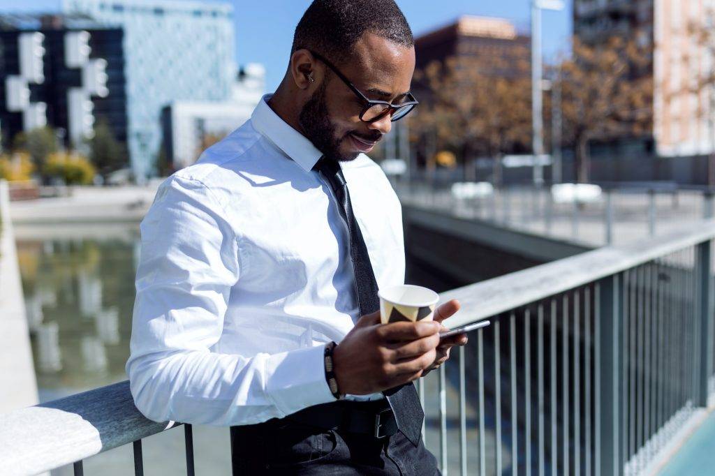 Handsome elegant man with coffee and phone